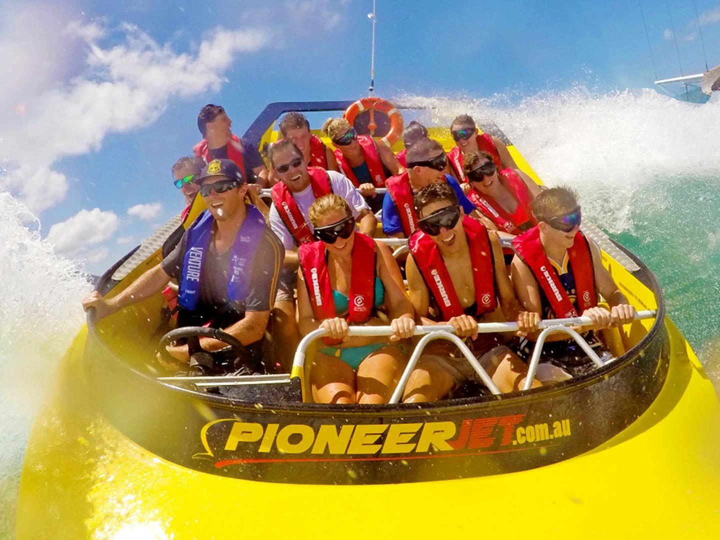 a group of people riding on the back of a boat