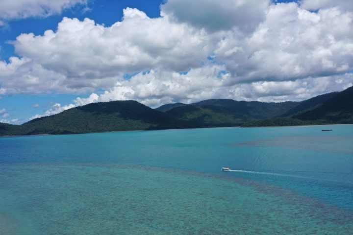 a body of water with a mountain in the background