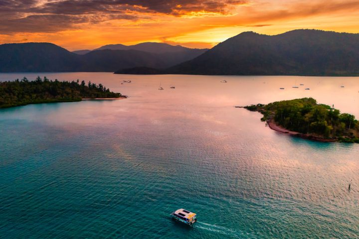 a body of water with a mountain in the background
