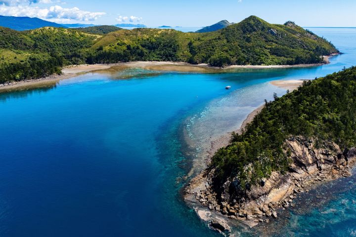 an island in the middle of a lake surrounded by a body of water