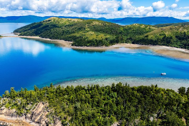 an island in the middle of a lake surrounded by a body of water