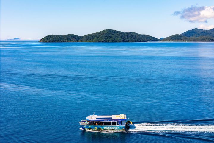 a blue and white boat floating on a body of water