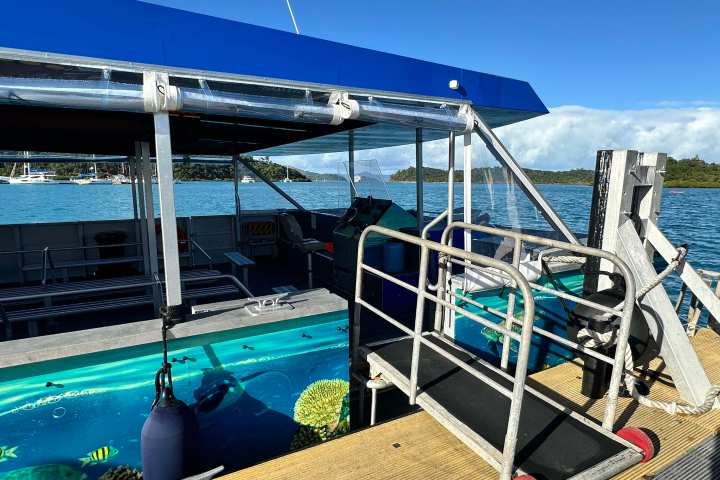 a boat sitting on top of a wooden fence