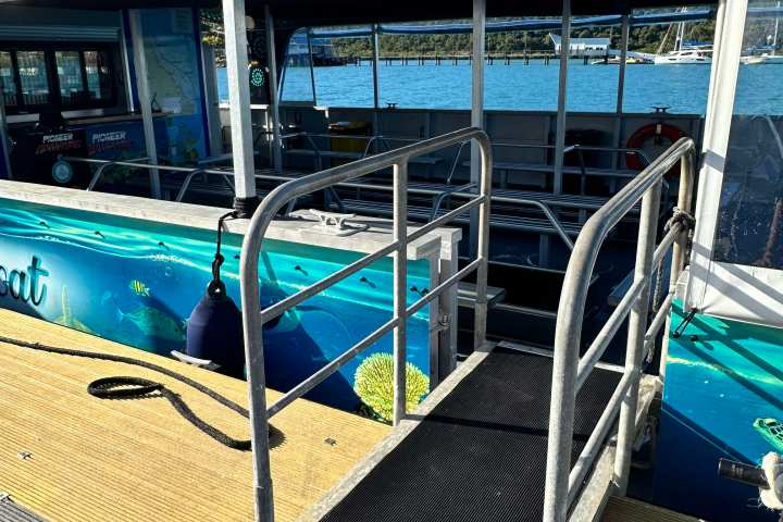 a bus that is sitting on the side of a boat